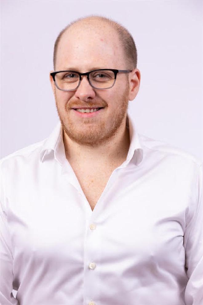 Headshot of Tim O'Brien smiling